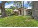 Charming single-story home featuring a brick archway, lush lawn, and mature trees at 3001 Folklore Dr, Valrico, FL 33596