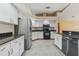 Stylish kitchen showcasing white cabinetry, granite counters, and modern stainless steel appliances at 3001 Folklore Dr, Valrico, FL 33596