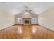 Spacious living room featuring a brick fireplace and wood parquet flooring at 3001 Folklore Dr, Valrico, FL 33596