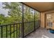 Private balcony with metal railings overlooking lush greenery and water at 3062 Eastland Blvd # 402, Clearwater, FL 33761