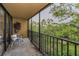 Balcony with a chair and a view of lush green trees and grassy lawn area at 3062 Eastland Blvd # 402, Clearwater, FL 33761