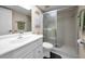 Bright bathroom featuring a modern vanity, a walk-in shower, and neutral tones at 3062 Eastland Blvd # 402, Clearwater, FL 33761