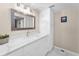 Bathroom features a marble countertop vanity and mirrored wall cabinet at 3062 Eastland Blvd # 402, Clearwater, FL 33761