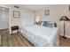 Cozy bedroom featuring wood floors, a queen bed, and serene décor at 3062 Eastland Blvd # 402, Clearwater, FL 33761