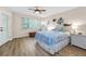 Well-lit bedroom with a nautical theme and wood-look floors and a door to the outside at 3062 Eastland Blvd # 402, Clearwater, FL 33761