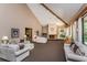 Large community clubhouse featuring couches, chairs, fireplace, and large windows at 3062 Eastland Blvd # 402, Clearwater, FL 33761
