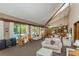 Large community clubhouse featuring couches, chairs, and large windows overlooking the pool at 3062 Eastland Blvd # 402, Clearwater, FL 33761