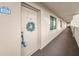 Condo entrance showing door #402 with a decorative wreath at 3062 Eastland Blvd # 402, Clearwater, FL 33761