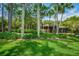 Lush landscaping surrounds this charming one-story home with a manicured lawn and mature trees at 3062 Eastland Blvd # 402, Clearwater, FL 33761
