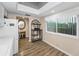 Kitchen showcasing sleek white cabinetry and a view to an adjacent dining space at 3062 Eastland Blvd # 402, Clearwater, FL 33761