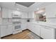 Clean, white kitchen equipped with modern appliances and ample cabinet space at 3062 Eastland Blvd # 402, Clearwater, FL 33761