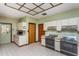 Functional kitchen features a vintage stove, ample cabinet space, and easy-to-clean tile floors at 3062 Eastland Blvd # 402, Clearwater, FL 33761
