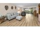 Bright living room with comfortable seating, modern decor, and access to a balcony with scenic views at 3062 Eastland Blvd # 402, Clearwater, FL 33761