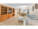 Spacious living room with wood flooring, built-in shelving, and comfortable seating for relaxing or entertaining at 3062 Eastland Blvd # 402, Clearwater, FL 33761