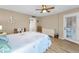 Bright main bedroom with light wood floors, beach decor, and access to a balcony at 3062 Eastland Blvd # 402, Clearwater, FL 33761