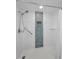Bright white tiled shower with decorative accent tile and a shower head with hand wand at 3062 Eastland Blvd # 402, Clearwater, FL 33761