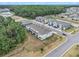 Aerial view showcasing the community's townhomes, landscaping, and surrounding wooded areas at 32803 Pez Landing Ln, Wesley Chapel, FL 33543