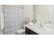 Charming bathroom with a patterned shower curtain, neutral walls, and modern fixtures at 32803 Pez Landing Ln, Wesley Chapel, FL 33543