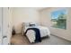 Comfortable bedroom featuring a window with natural light and neutral tones at 32803 Pez Landing Ln, Wesley Chapel, FL 33543