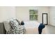 Cozy bedroom with natural light, neutral decor, and comfortable furnishings create a relaxing retreat at 32803 Pez Landing Ln, Wesley Chapel, FL 33543