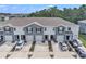 Exterior view of townhomes with well-maintained landscaping, garages, and driveway parking at 32803 Pez Landing Ln, Wesley Chapel, FL 33543