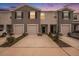 Beautiful two-story townhomes with attached garages and well-maintained landscaping in a row at 32803 Pez Landing Ln, Wesley Chapel, FL 33543