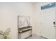 Inviting foyer features neutral paint colors, tile floors and a console table with decor at 32803 Pez Landing Ln, Wesley Chapel, FL 33543