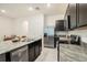 Spacious kitchen with stainless steel appliances, granite countertops, and island seating, perfect for entertaining at 32803 Pez Landing Ln, Wesley Chapel, FL 33543