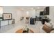 Bright and inviting living room flowing seamlessly into the kitchen area, featuring tile floors at 32803 Pez Landing Ln, Wesley Chapel, FL 33543