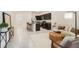 Bright and inviting living room flowing seamlessly into the kitchen area, featuring tile floors at 32803 Pez Landing Ln, Wesley Chapel, FL 33543