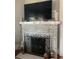 Close up of living room fireplace with decorative iron screen and stone hearth at 336 9Th Ne Ave, St Petersburg, FL 33701