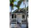 Inviting front porch with white railings, steps and a porch swing, framed by palm trees, enhancing curb appeal at 336 9Th Ne Ave, St Petersburg, FL 33701