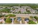 Neighborhood view showcasing the house, surrounding houses, lawns, and community layout at 3434 St Ives Blvd, Spring Hill, FL 34609