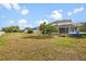 Large backyard with a screened-in lanai and ample space for outdoor activities at 3434 St Ives Blvd, Spring Hill, FL 34609