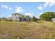 Large backyard features grass, trees and a screened in lanai with a pool at 3434 St Ives Blvd, Spring Hill, FL 34609