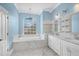 Bright bathroom with a soaking tub under an arched window at 3434 St Ives Blvd, Spring Hill, FL 34609