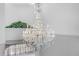 Elegant chandelier with crystal embellishments and candle-style lights, enhancing the home's luxurious ambiance at 3434 St Ives Blvd, Spring Hill, FL 34609