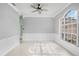 Dining room with white marble floors, wainscoting, crown molding, and arched window at 3434 St Ives Blvd, Spring Hill, FL 34609