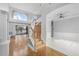 Open-concept entryway with hardwood and marble floors, staircase, and soaring window at 3434 St Ives Blvd, Spring Hill, FL 34609
