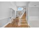 Bright entryway featuring wood and tile flooring, staircase, and natural light at 3434 St Ives Blvd, Spring Hill, FL 34609