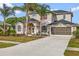 Stunning two-story home features lush landscaping, an attached two-car garage, and a well-maintained driveway at 3434 St Ives Blvd, Spring Hill, FL 34609