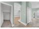 Hallway showcasing a view of an open floor plan and a storage closet at 3434 St Ives Blvd, Spring Hill, FL 34609