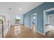 Upstairs hallway features hardwood floors, arched windows, and white and blue walls at 3434 St Ives Blvd, Spring Hill, FL 34609