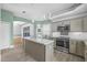 Stylish kitchen featuring an island, stainless steel appliances, and decorative tile backsplash at 3434 St Ives Blvd, Spring Hill, FL 34609