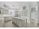 Bright kitchen features gray cabinetry, island, stainless steel appliances, and modern lighting at 3434 St Ives Blvd, Spring Hill, FL 34609