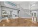 Open-concept living space featuring hardwood floors, fireplace, and staircase at 3434 St Ives Blvd, Spring Hill, FL 34609