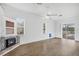 Open-concept living area with fireplace, wood floors, and sliding doors to the outdoors at 3434 St Ives Blvd, Spring Hill, FL 34609