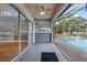 Covered patio boasts tile flooring, a ceiling fan, and overlooks the pool at 3434 St Ives Blvd, Spring Hill, FL 34609