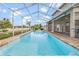 A screened-in pool with a hot tub and water feature offers backyard fun at 3434 St Ives Blvd, Spring Hill, FL 34609