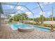 Large pool with spa and water feature in a screened-in enclosure at 3434 St Ives Blvd, Spring Hill, FL 34609
